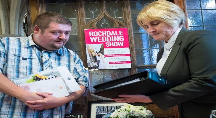 A visitor to the Rochdale Wedding Show booking a registrar.