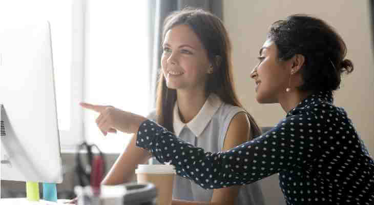 Manager and apprentice in office.