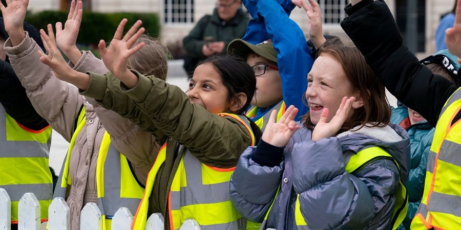 Visiting schoolchildren waving at Lilly.