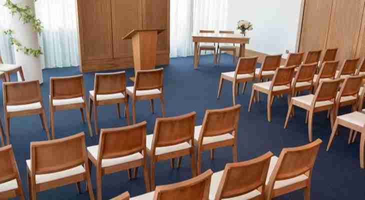 Rows of seats laid out for wedding guests in the Red Rose Suite.