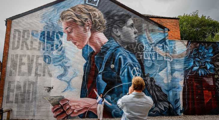 Visitors posing in front of one of the new murals.