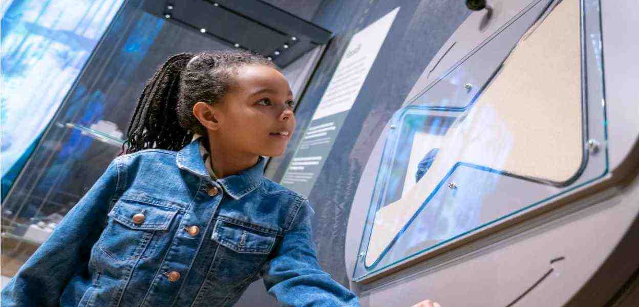 Child examining an exhibit at the Dippy on Tour exhibition.