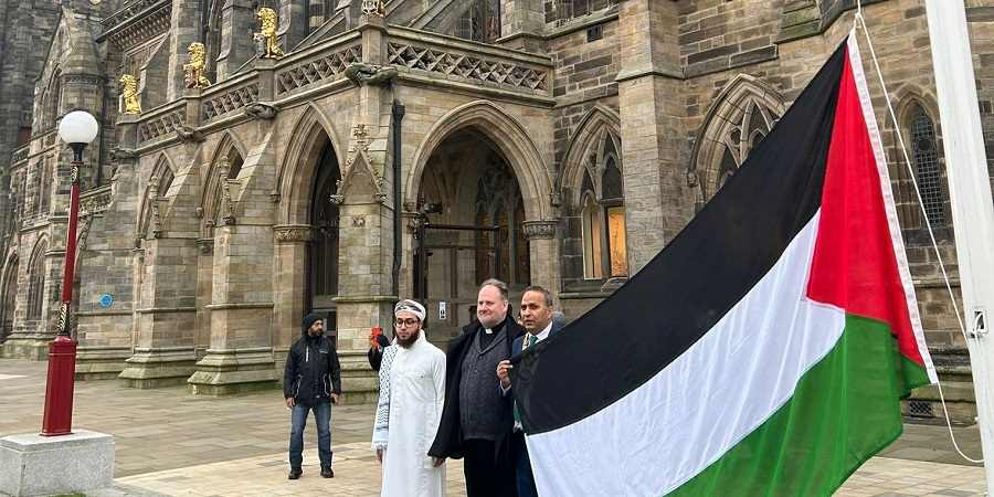 The mayor of Rochdale and guests with the Palestinian flag outside Rochdale Town Hall.