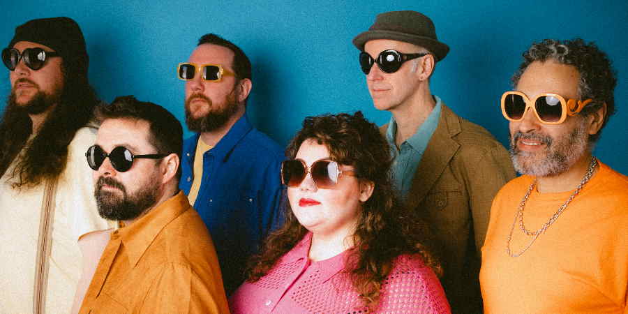 Portrait of Rioghnach Connolly and Honeyfeet wearing sunglasses against a plain background.