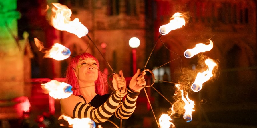 Performer with lit torches.