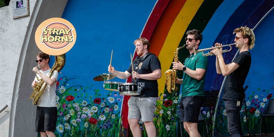 Stray Horns performing in the bandstand in Queens Park.