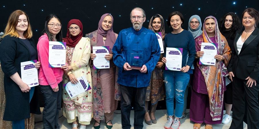 Students of Talk English with their certificates.