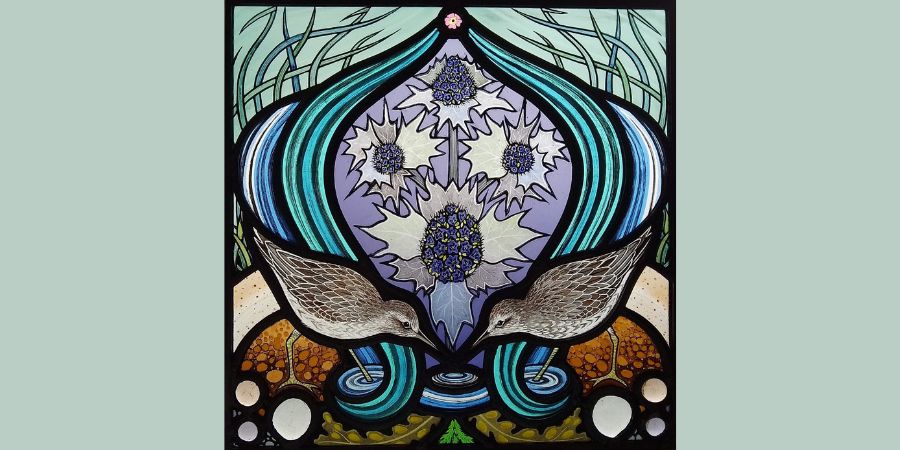 A panel of stained glass featuring 2 birds.