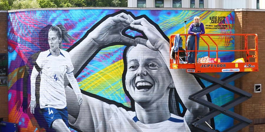 Katie Scott in front of the completed mural.