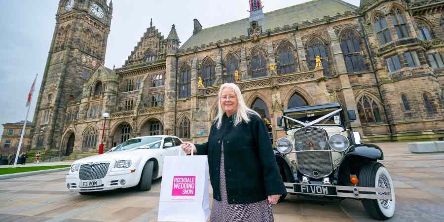 Councillor Sue Smith and 2 wedding cars in front of town hall.