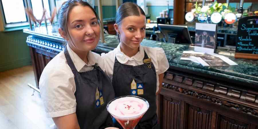 Bar staff with cocktail.