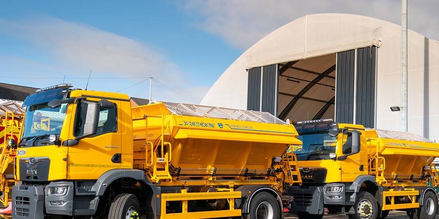 A row of parked snow gritters.