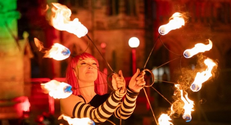 Performer with lit torches.