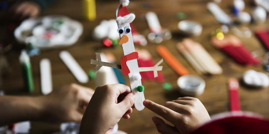 A child crafting a snowman.