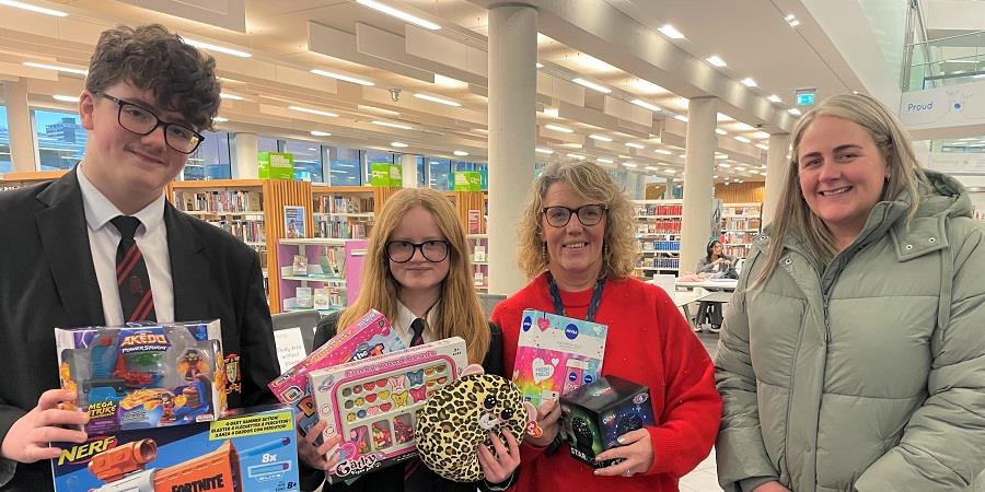 Helen Walton from the Rochdale Giving Back Christmas Toy Appeal with Cardinal Langley School pupils Oliver and Lucy.