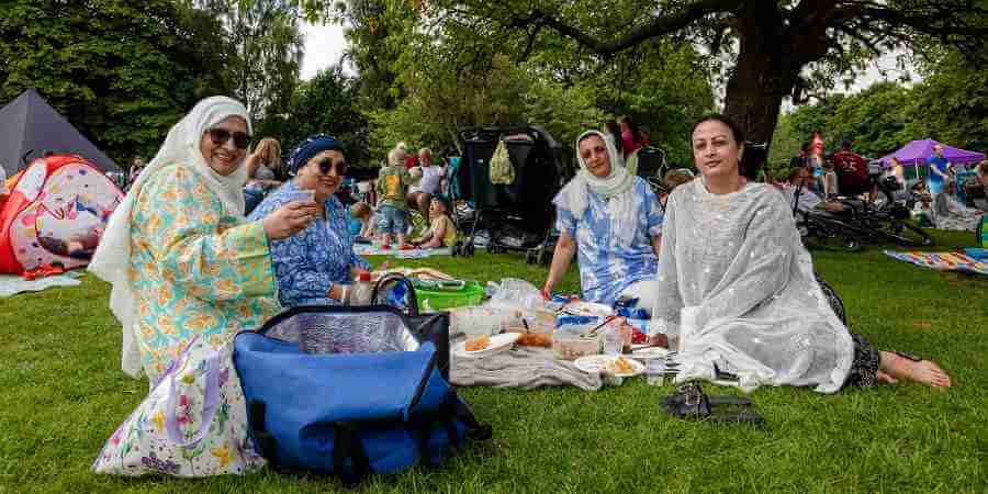 Visitors to the Feel Good Family Picnic sat on a picnic mat.