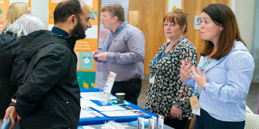 A resident speaking to a council staff member about jobs.